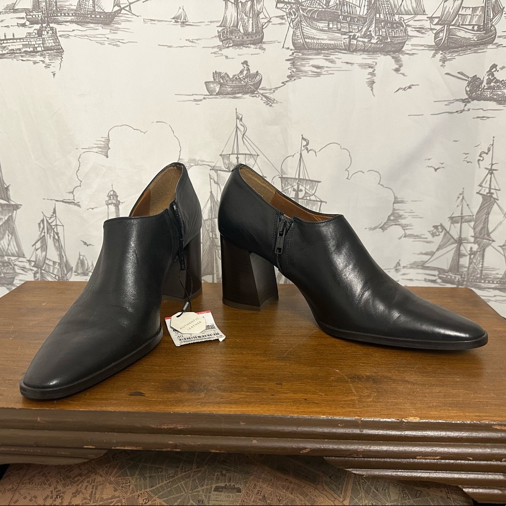 Black leather ankle boots with block heel and zipper detail. Size 9